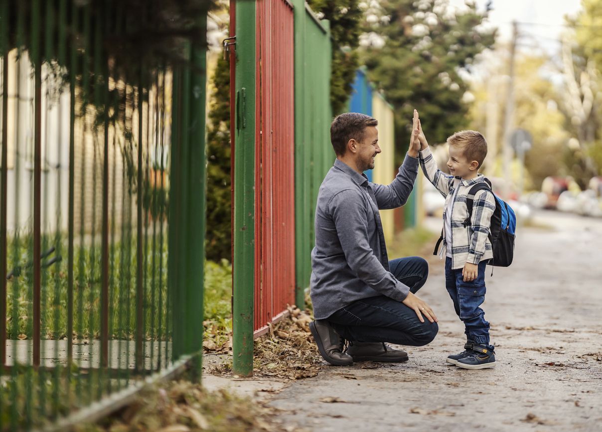 A father high-fives his son